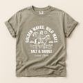 Vintage grey t-shirt with a white graphic of a cowgirl riding a horse along the beach. The girl is holding a surfboard. The text says salt and saddle, Central Florida. Coastal Cowgirl theme.