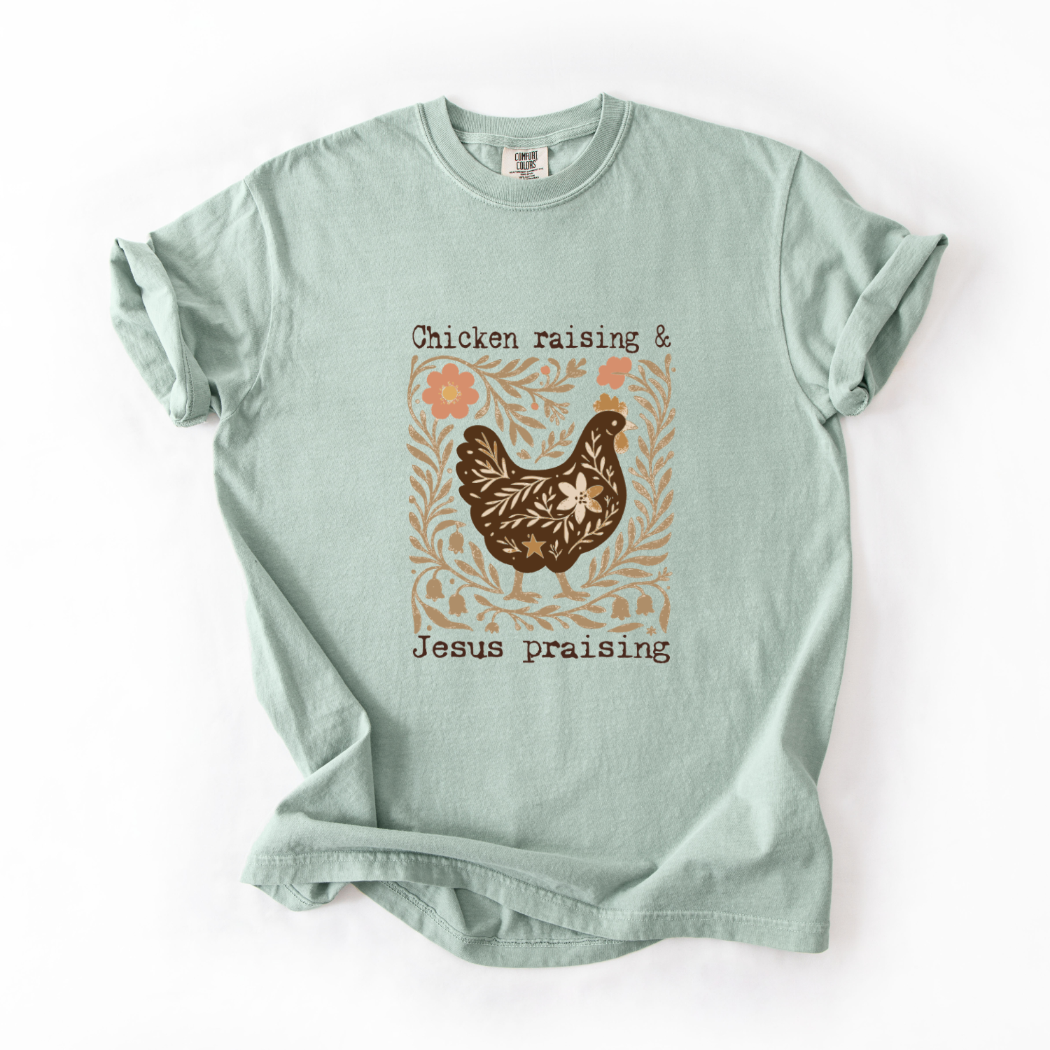 Light green t-shirt with a chicken and floral design on a white background