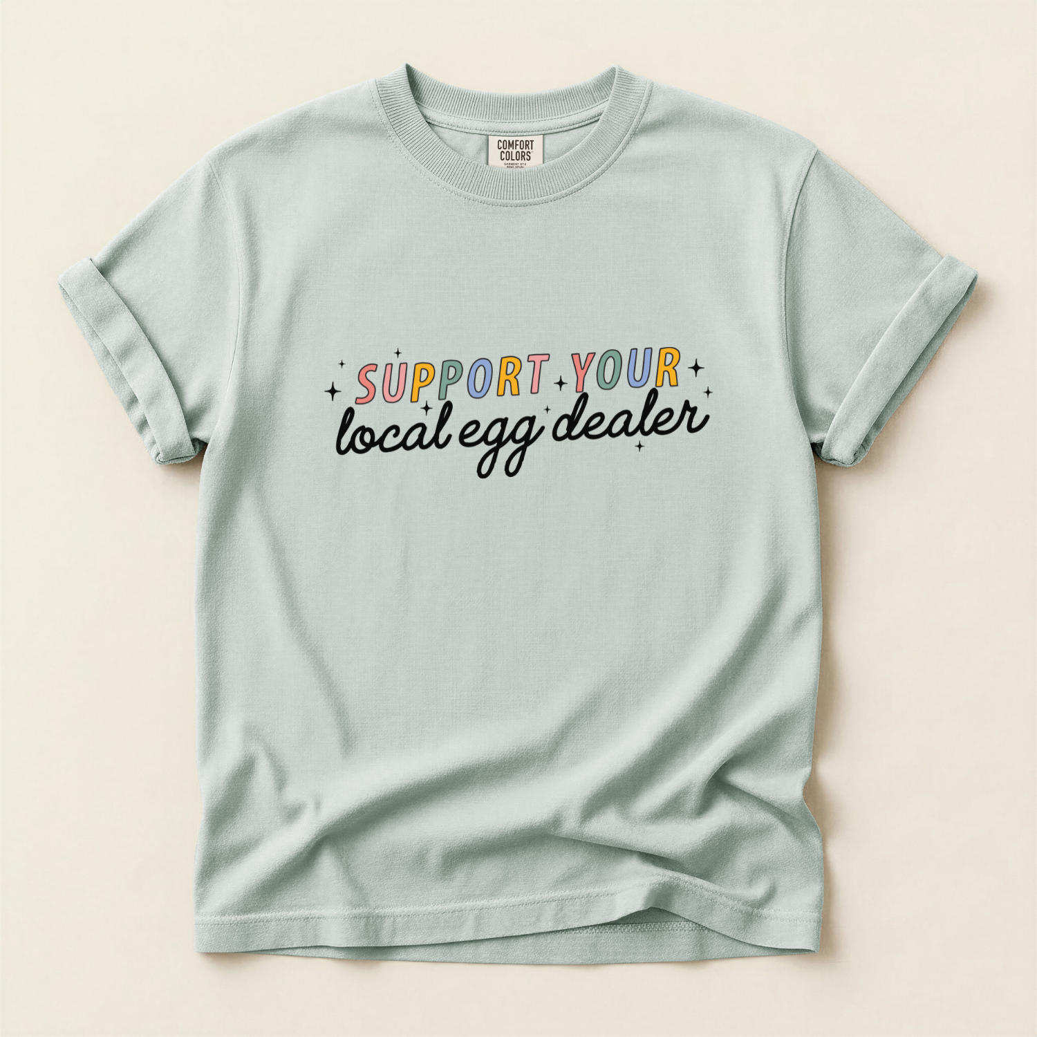 Bay colored comfort colors t-shirt with 'Support your local egg dealer' text for homestead and chicken lovers