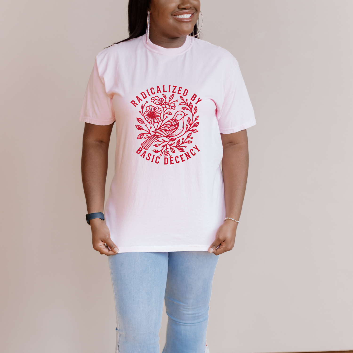 Social Justice tee with red floral and bird graphic that says "radicalized by basic decency