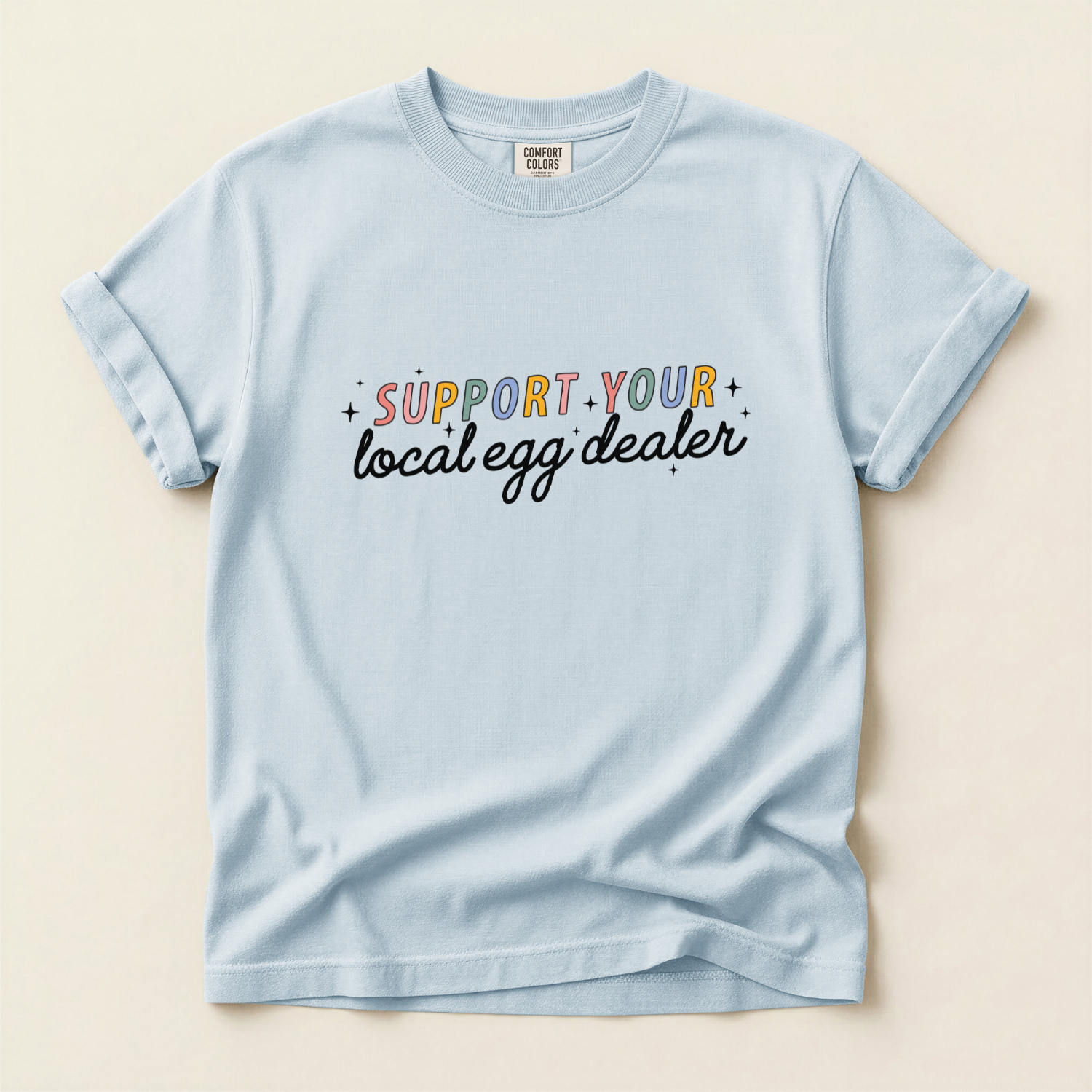 Chambray Blue comfort colors t-shirt with "support your local egg dealer" text in colorful font