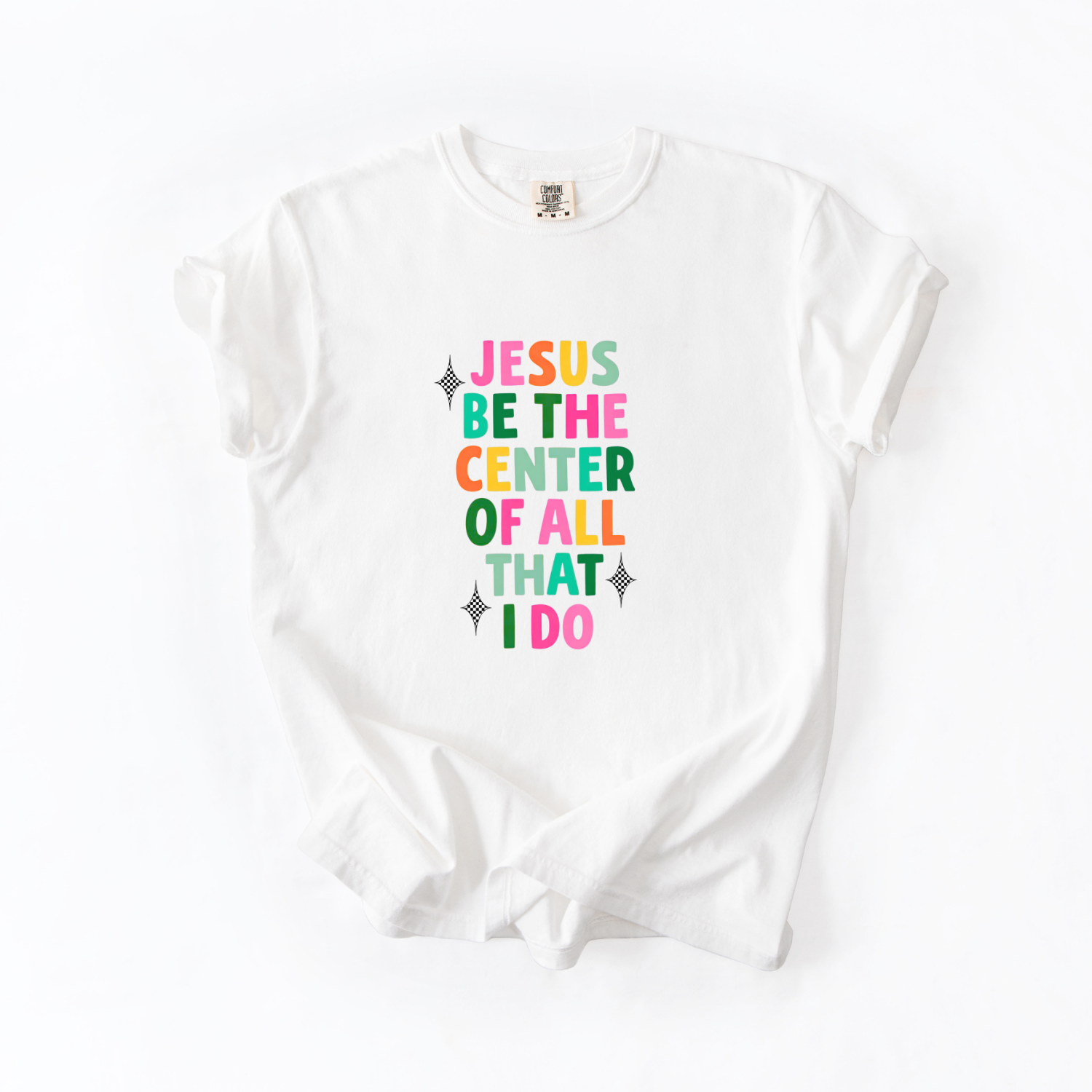 White sleeveless shirt with colorful text that reads "jesus be the center of all I do" design on a white background
