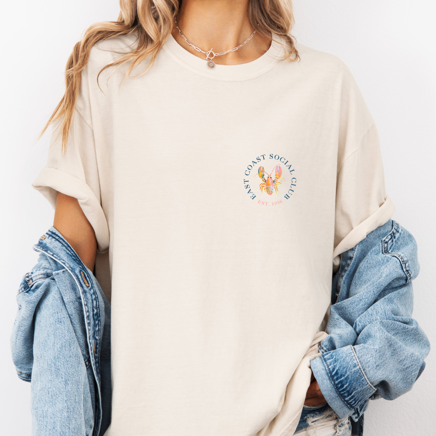 Ivory colored tee with a pastel colored preppy lobster illustration
