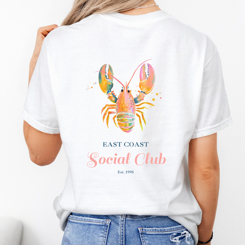White comfort colors tshirt with a bright pink lobster and the words "east coast social club"