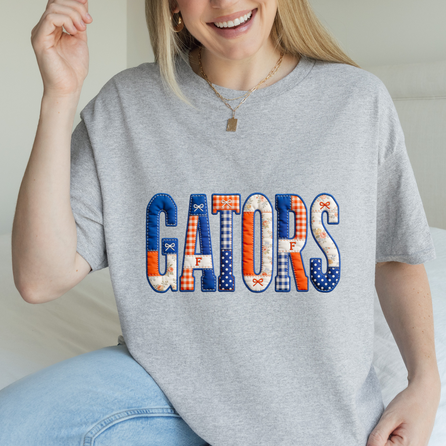 Orange and blue patchwork lettering on a sport grey tee that reads GATORS