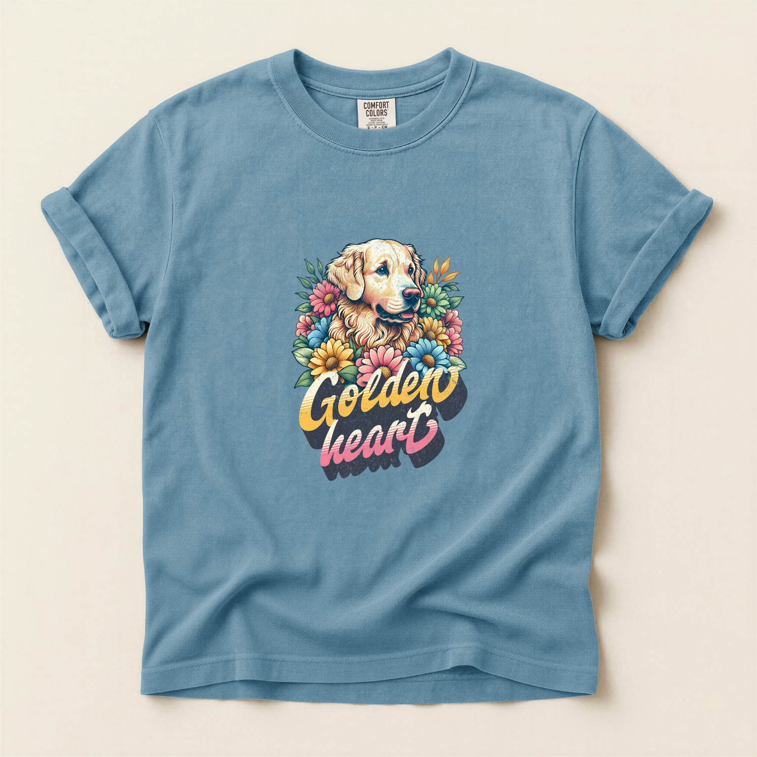 Blue shirt with a graphic of a golden retriever surrounded by flowers and words that say "golden heart"