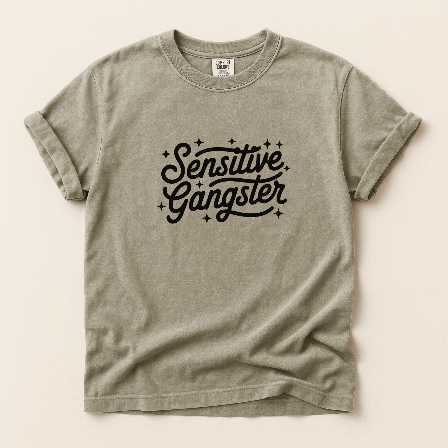 Khaki t-shirt with 'Sensitive Gangster' text on a beige background