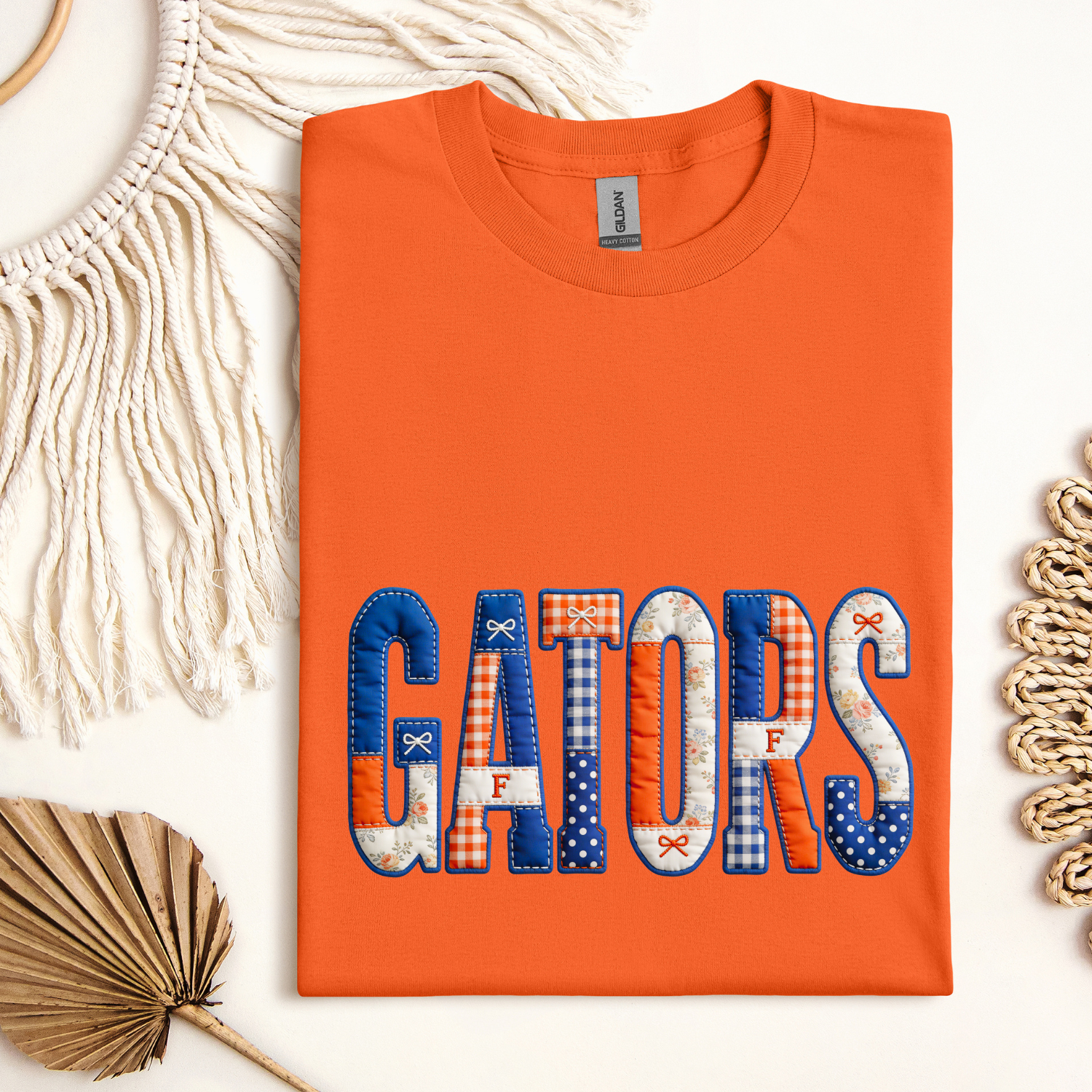 Orange t-shirt with 'GATORS' text on a decorative background
