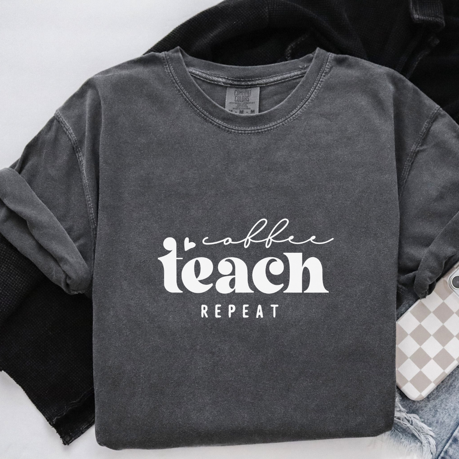 Dark gray shirt with 'coffee teach repeat' text on a white background