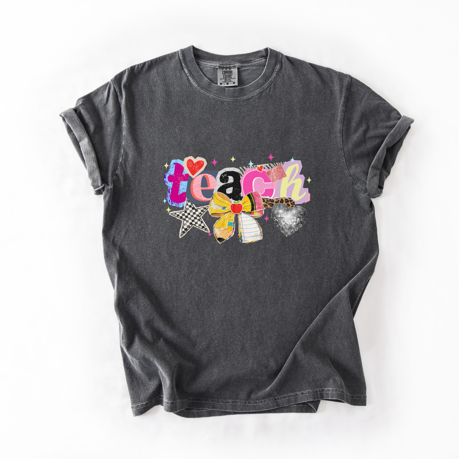 Black t-shirt with colorful 'teach' design with stars, glitter disco ball and hearts on a white background