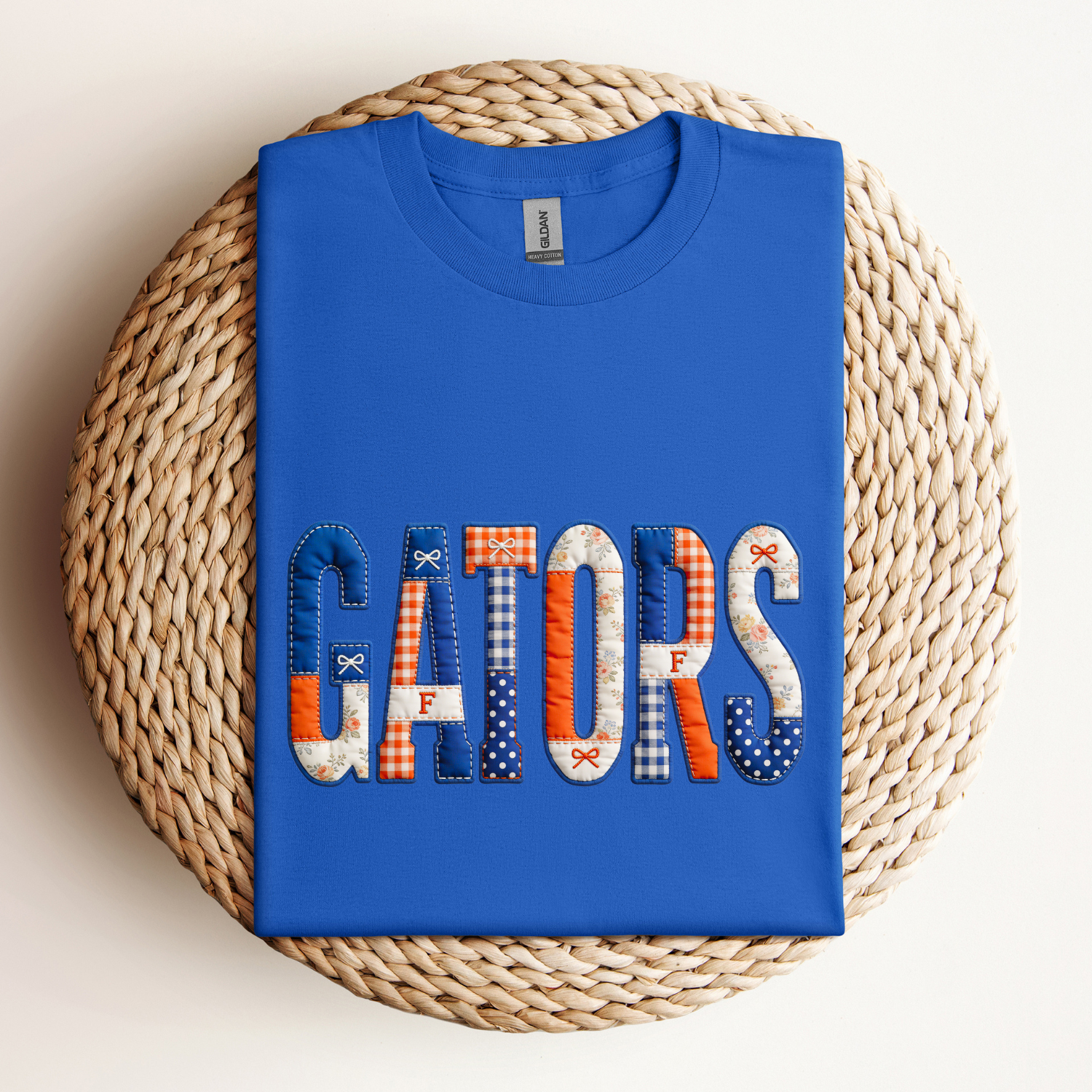 Royal blue gators tee with text in a patchwork pattern of white, orange and blue that reads gators