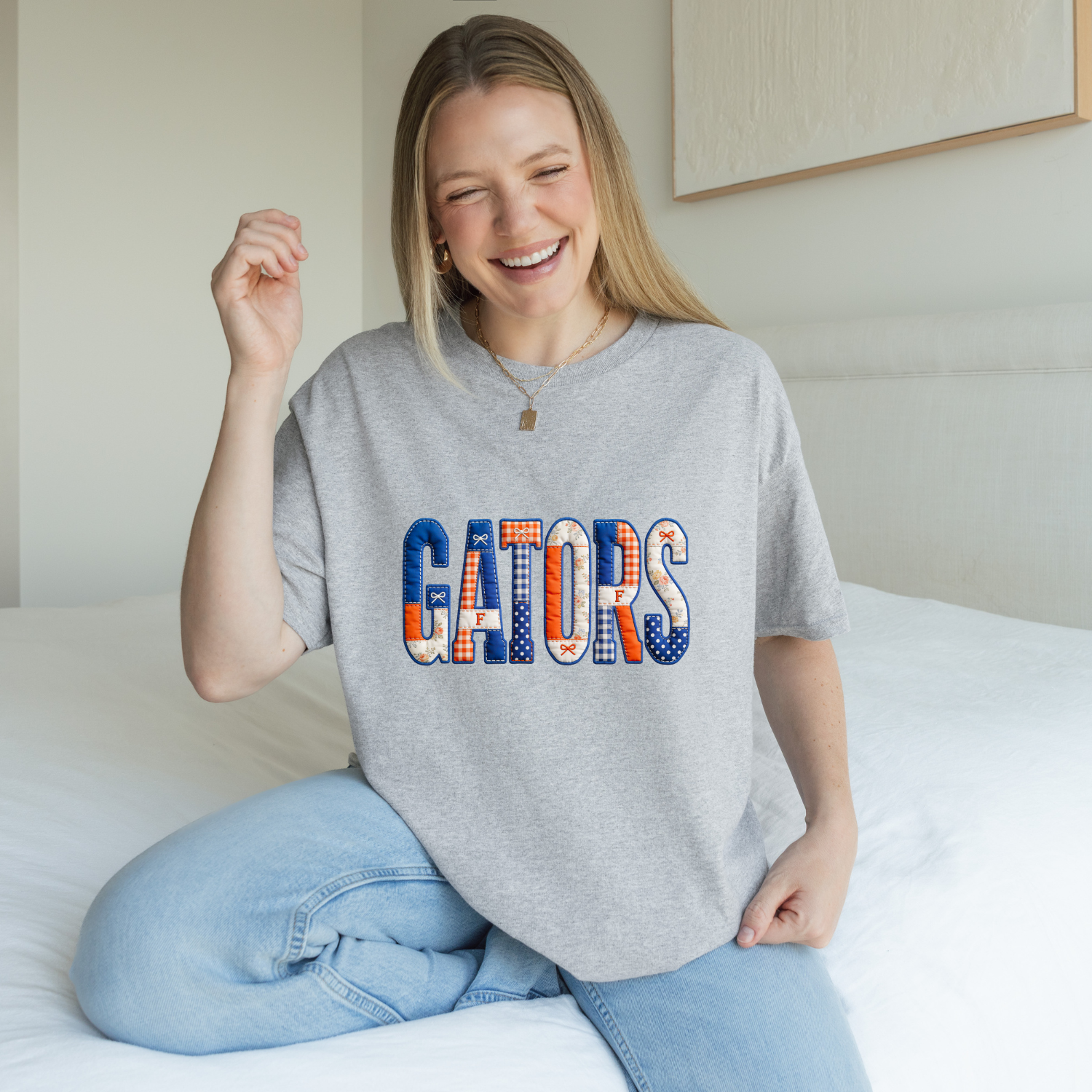 Florida Gators pride tee with a quilted patchwork lettering that reads gators in all caps. The tee is sport grey and the colors are orange and blue