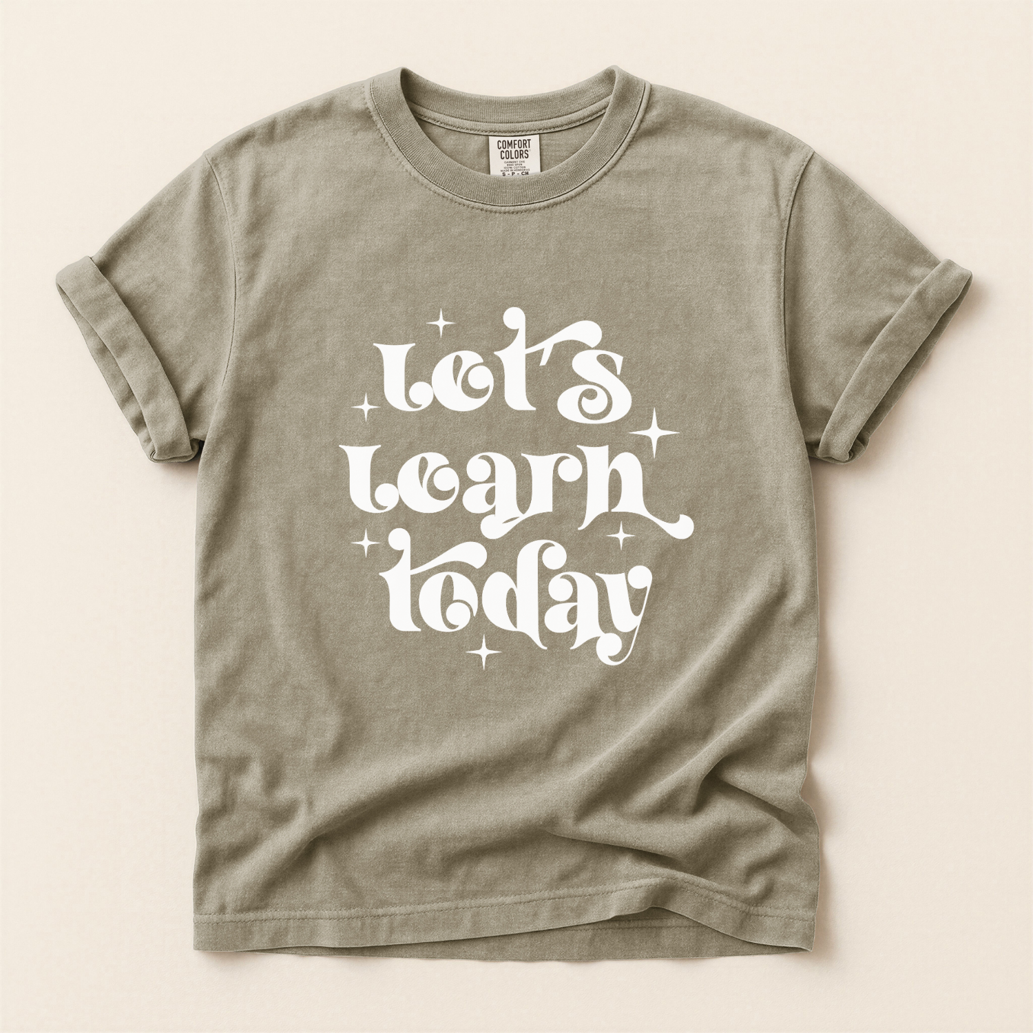 Vintage khaki colored comfort colors tee with the text that reads "let's learn today", teacher tshirt